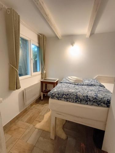 mała sypialnia z łóżkiem i oknem w obiekcie Tiny House for Two w Braszowie