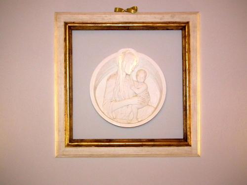 a framed drawing of a woman holding a baby at Suite Umberto I in Assisi