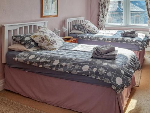 two beds sitting next to each other in a bedroom at Causey Pike in Keswick