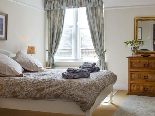 a bedroom with a bed with towels on it at Causey Pike in Keswick