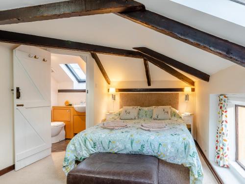 a bedroom with a bed and a bathroom at Orchard Cottage - Uk30437 in Kingsbury Episcopi