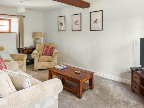a living room with a couch and a coffee table at The Swallows - Uk50177 in Mare Green