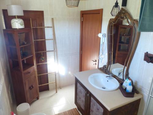 a bathroom with a sink and a mirror at Sandra B&B in Luz de Tavira