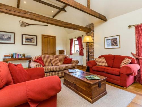 a living room with two couches and a coffee table at Anvil Cottage in Louth