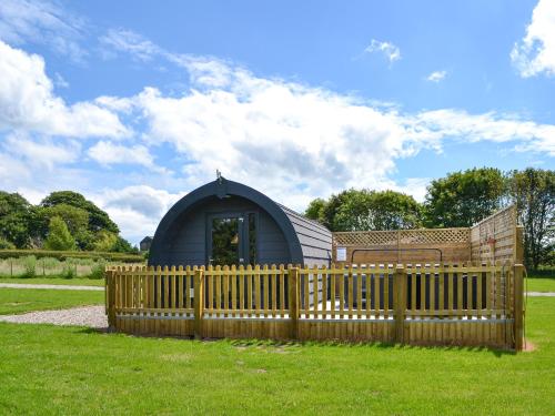 a wooden fence in front of a dome house at Sycamore - Uk47621 in Hunmanby