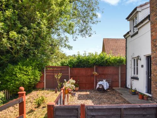 a backyard with a fence and a wooden gate at Riverside in March