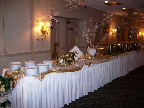 a long table with plates and bowls on it at 1863 Inn of Gettysburg in Gettysburg