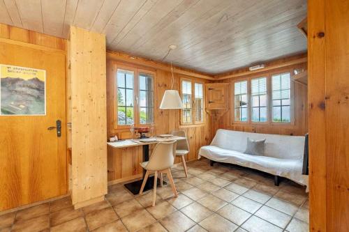 a bedroom with a bed and a desk and a table at Mountainview Fireplace & Garden Bbq in Axalp
