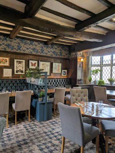 a dining room with a table and chairs at The Angel Inn Hotel in Pershore