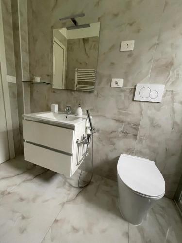 a bathroom with a sink and a toilet and a mirror at Bellavista in Brezzo