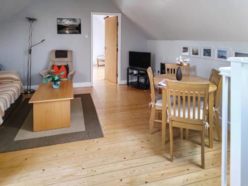 a living room with a table and a dining room at Elm Loft in Upton