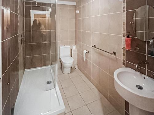 a bathroom with a toilet and a sink at Murton Cottage in East Ord
