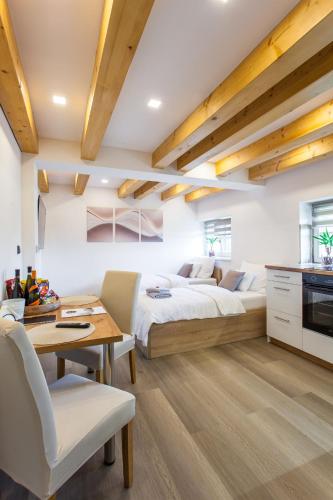 a bedroom with a bed and a table and a kitchen at Aparthotel Svitavy in Svitavy