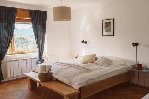 a bedroom with a large bed and a window at Kmetija Pečnik in Prevalje