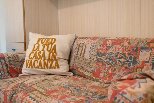a couch with a pillow on top of it at M314 - Marcelli, comodo trilocale a 200mt dal mare in Marcelli