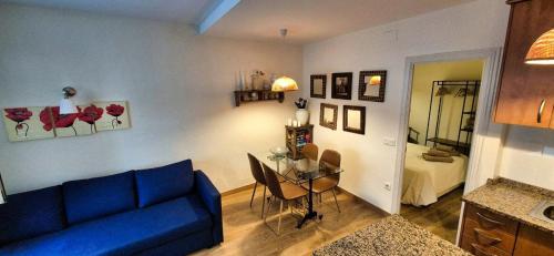 a living room with a blue couch and a table at Les Flors !2minutos de la playa! in Lloret de Mar
