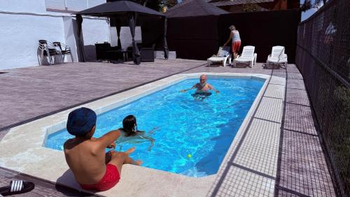 a group of people playing in a swimming pool at Espacio Kybalion in Argentona