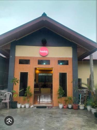 a building with a sign on the front of it at The Sanduk Inn in Rantepao