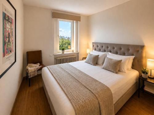 a bedroom with a large bed and a window at Tallinn Residence 1937 in Tallinn