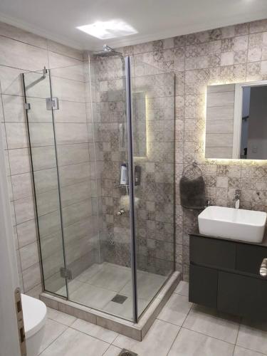 a bathroom with a shower and a sink at Villa Little John in Skala Rachoniou