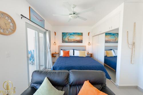 a bedroom with a bed and a couch at Ideal accommodation for couples Sosúa, Santa Fe in Sosúa