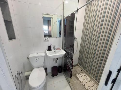 a bathroom with a toilet and a shower and a sink at Cozy house in El Aouina Station