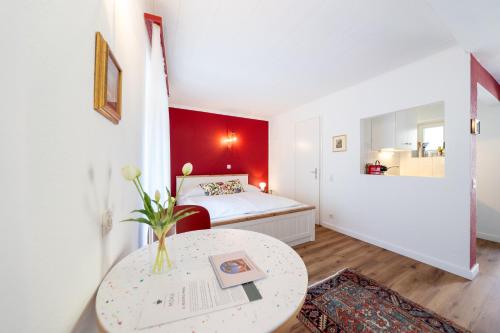 a small room with a bed and a table at Residenza Motta - Boutique Apartments in Locarno