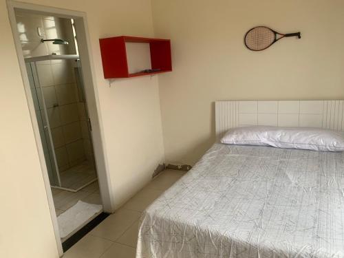 a small bedroom with a bed and a shower at Casa de Praia do Abais in Estância