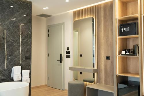 a bathroom with a sink and a mirror at Erdeti Boutique Hotel in Sarandë