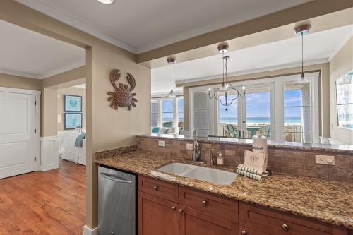 a kitchen with a sink and a large mirror at A112 Stella Aurea on 30A in Santa Rosa Beach
