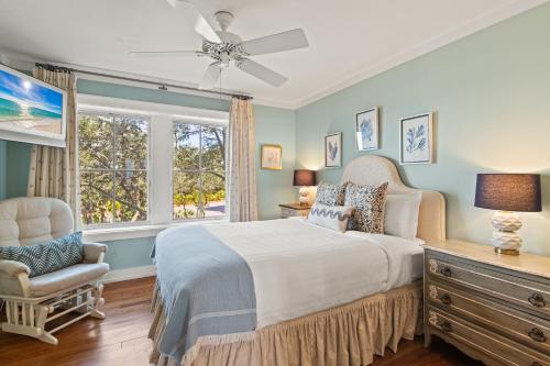 a bedroom with a bed and a chair and a window at A112 Stella Aurea on 30A in Santa Rosa Beach