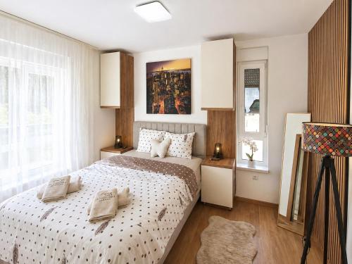 a bedroom with a bed and a painting on the wall at Panorama Gold in Soko Banja