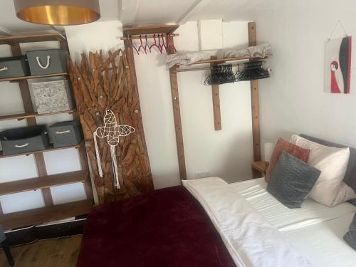 a room with a bed and a wall with shelves at Lahn-Paradies in Aull