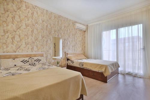 a bedroom with two beds and a window at A very, very special residential unit in Madinaty