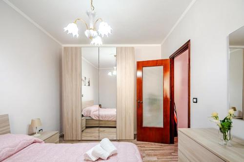 a bedroom with a pink bed and a mirror at Nido della Rondine in Bagnoregio