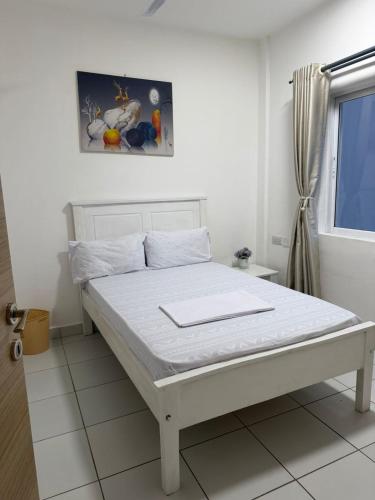 a white bed in a room with a window at Stylish 2BR Pool, Gym Garden in Mombasa