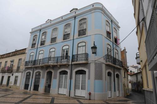 a blue and white building on a street at Legendary Bay - Suíte Temática in Seixal