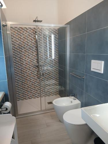 a bathroom with a shower with a toilet and a sink at B&B Casaletto in San Nicola Arcella