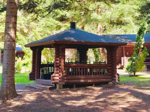 a small wooden gazebo in a park at Villas Jagoda & Malina in Borovets