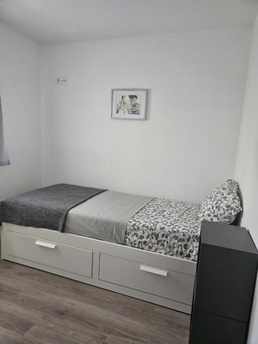 a bedroom with a bed with a dresser and a desk at El capricho in Fuengirola
