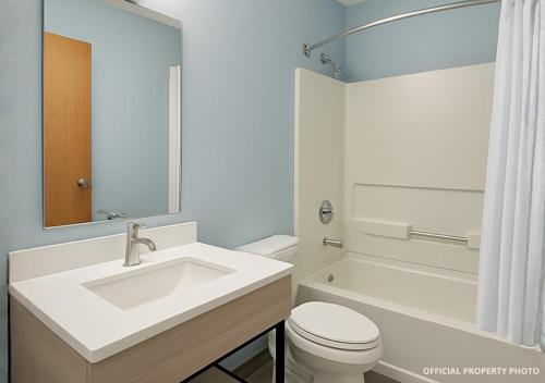 a white bathroom with a sink and a toilet at Hotel Butler Inn in Butler