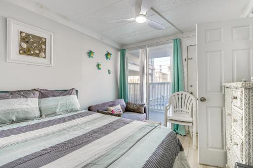 a bedroom with a bed and a chair and a window at Beachfront Wildwood Crest Condo w/ Pool Access! in Wildwood Crest