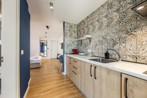 a kitchen with a sink and a counter top at Love in Colours by PikHost in Durrës