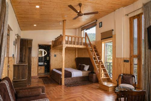 a bedroom with a bunk bed and a staircase at Hotel Amadeus in Kanatal