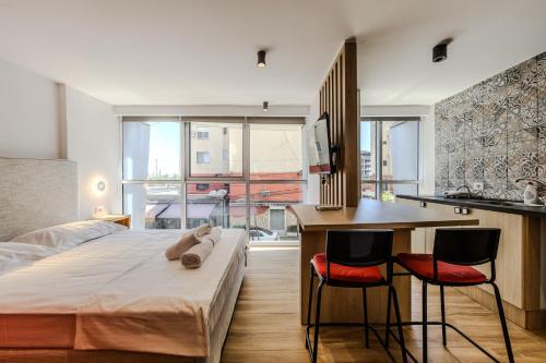 a bedroom with a bed and a desk with two chairs at Love in Colours by PikHost in Durrës