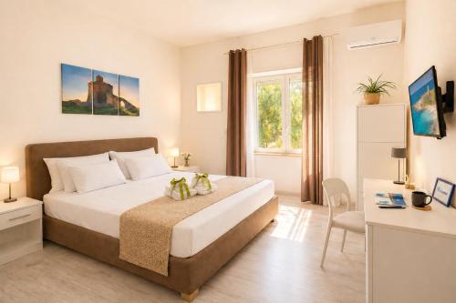 a bedroom with a bed and a desk in a room at RestHouse The Village in Nardò