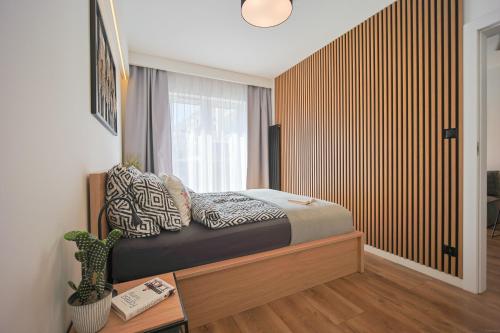 a bedroom with a bed and a window at Mała Poleska - przytulny apartament z ogródkiem in Częstochowa
