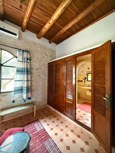 a room with a door and a room with a bathroom at Riad Titima Essaouira in Essaouira