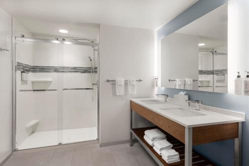 a bathroom with a sink and a shower at EVEN Hotel Alpharetta - Avalon Area by IHG in Alpharetta