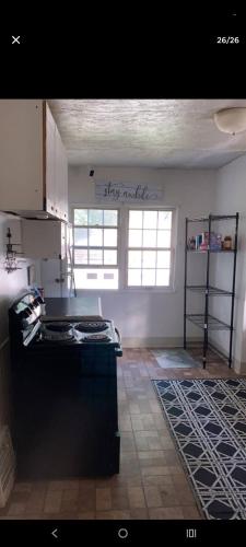 a kitchen with a stove top in a room at NH room rental in Akron